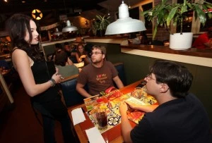 DJ Qualls from TNT's Memphis Beat And Liz Gillies from Nickelodeon's VicTORIous Participate As VIP Servers At Chili's In Encino